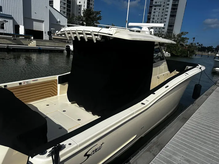  Yacht Photos Pics 2025 Scout 400 LXF boat docked at marina, showcasing sleek design and modern features.