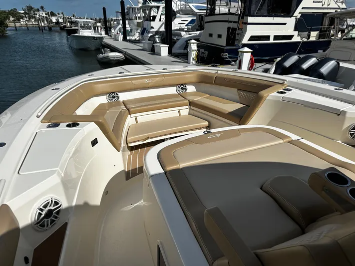  Yacht Photos Pics 2025 Scout 400 LXF boat interior with tan seating, docked at marina.