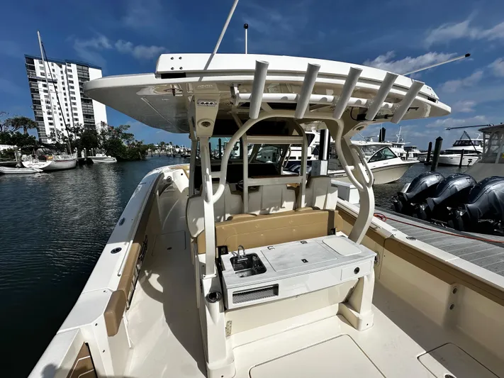  Yacht Photos Pics 2025 Scout 400 LXF boat docked, featuring a sleek design and modern amenities.