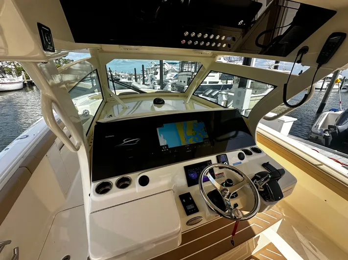  Yacht Photos Pics 2025 Scout 400 LXF boat cockpit with advanced navigation system and steering wheel.