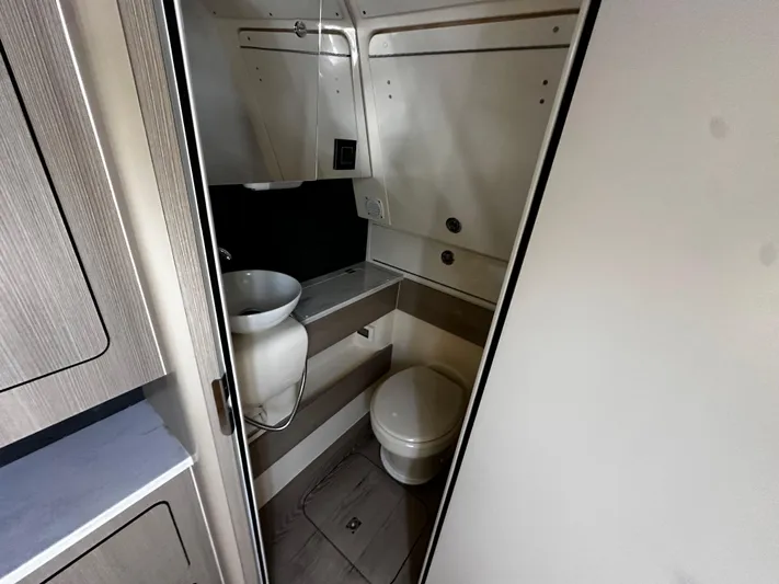  Yacht Photos Pics 2025 Scout 400 LXF boat bathroom interior with sink and toilet.
