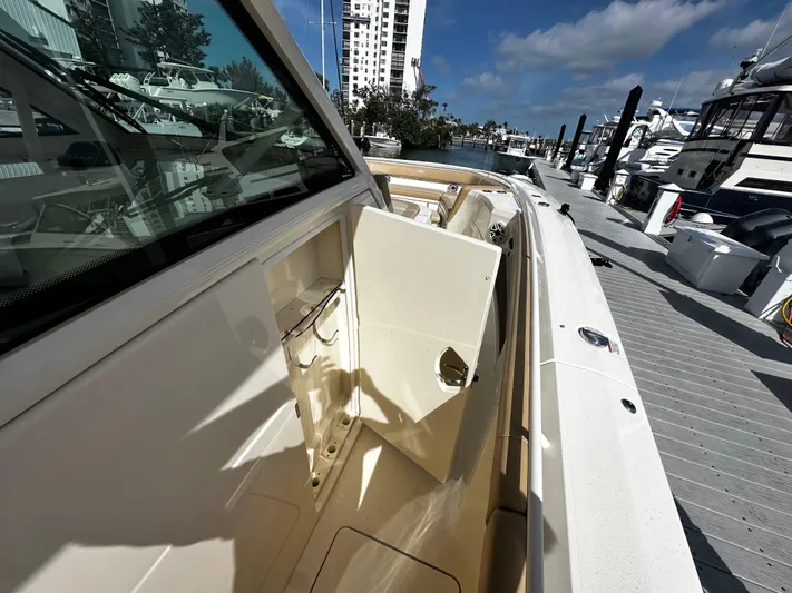 Yacht Photos Pics 2025 Scout 400 LXF boat docked, showcasing sleek design and luxurious features.