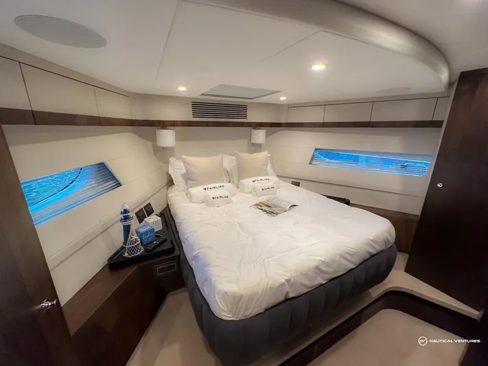  Yacht Photos Pics Luxurious bedroom interior of 2023 Fairline Phantom 65 yacht with modern design.