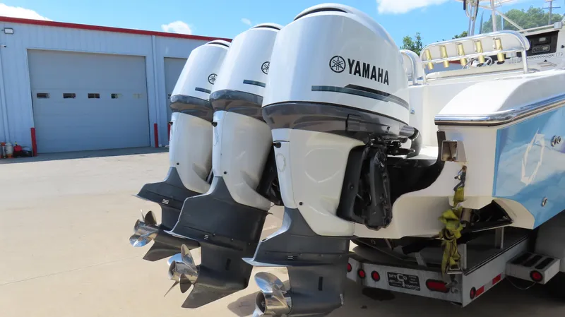  Yacht Photos Pics Four Yamaha outboard motors on a 2002 Fountain 38 TE boat, parked near a garage.