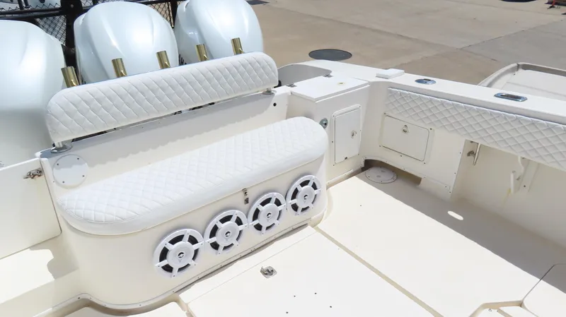  Yacht Photos Pics 2002 Fountain 38 TE boat interior with white seating and multiple speakers.