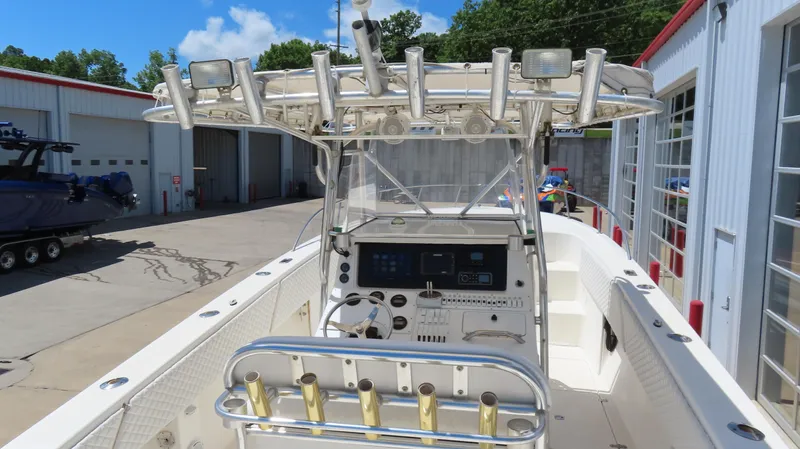  Yacht Photos Pics 2002 Fountain 38 TE boat with center console and rod holders, docked at a marina.