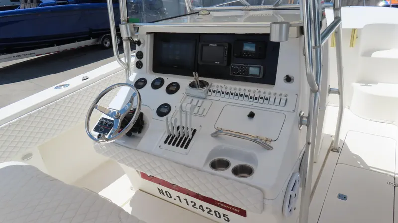  Yacht Photos Pics 2002 Fountain 38 TE boat dashboard with steering wheel and control panel.