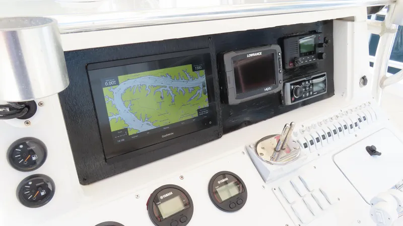  Yacht Photos Pics Control panel of a 2002 Fountain 38 TE boat with navigation and communication equipment.