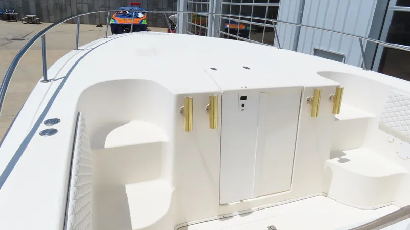  Yacht Photos Pics 2002 Fountain 38 TE boat deck with white seating and storage compartments.