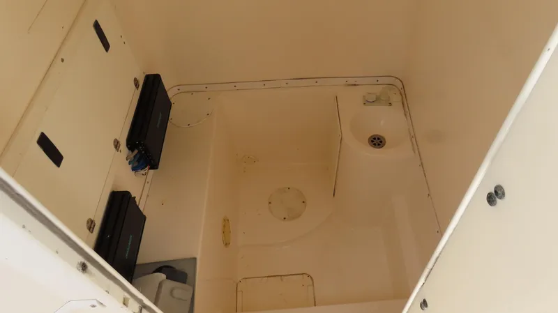  Yacht Photos Pics 2002 Fountain 38 TE boat interior compartment with storage and drainage features.
