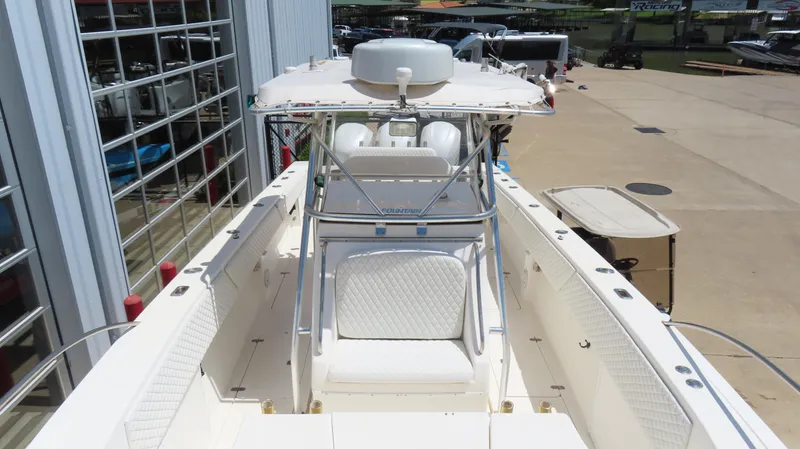  Yacht Photos Pics 2002 Fountain 38 TE boat with center console and seating, docked near a marina.