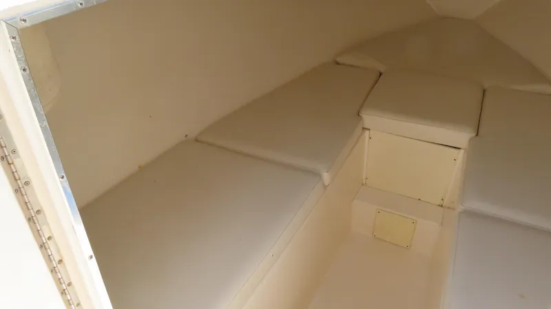  Yacht Photos Pics 2002 Fountain 38 TE boat interior cabin with cushioned seating and storage.