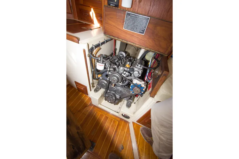 Equanimity Yacht Photos Pics Engine compartment of a 1992 Pacific Seacraft 37 sloop, showcasing detailed mechanical components.