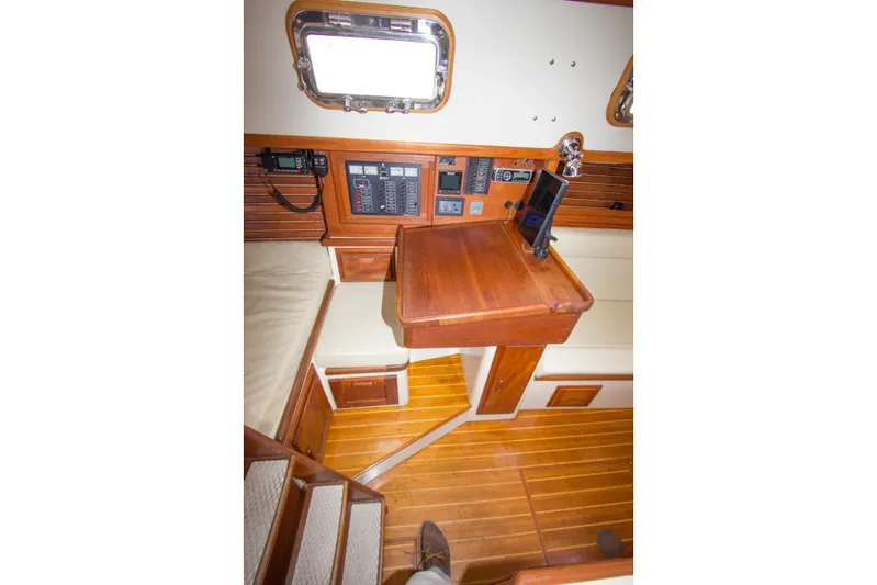 Equanimity Yacht Photos Pics 1992 Pacific Seacraft Cutter interior with navigation station and wooden flooring.