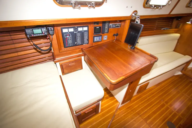 Equanimity Yacht Photos Pics 1992 Pacific Seacraft Cutter interior with navigation station and wooden furnishings.