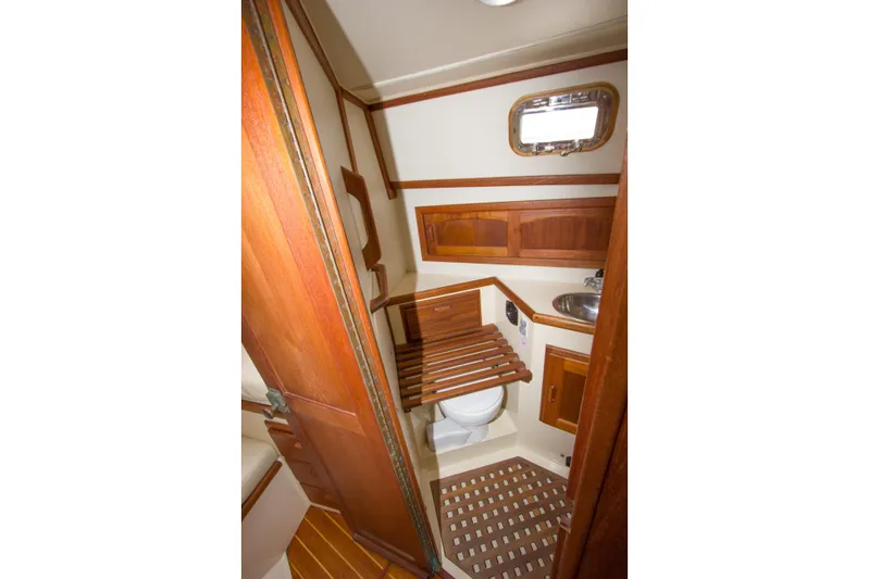 Equanimity Yacht Photos Pics 1992 Pacific Seacraft Cutter yacht bathroom with wooden accents and compact design.