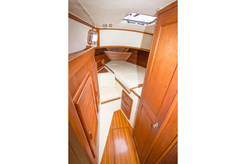 Equanimity Yacht Photos Pics 1992 Pacific Seacraft Cutter interior with wooden cabinetry and cozy sleeping area.
