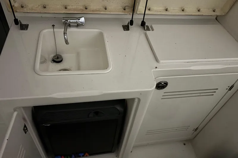  Yacht Photos Pics 2005 Silverton 34 Convertible boat interior with sink and storage compartments.