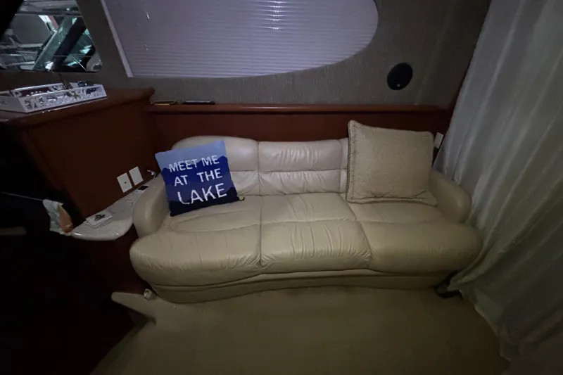  Yacht Photos Pics Luxurious interior of 2005 Silverton 34 Convertible with cream leather sofa and decorative pillows.