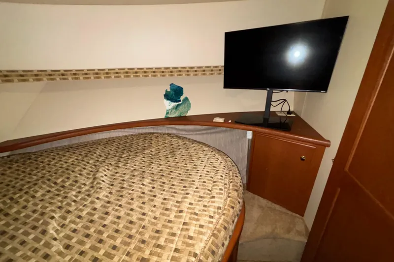  Yacht Photos Pics Interior of 2005 Silverton 34 Convertible with bed and mounted TV.