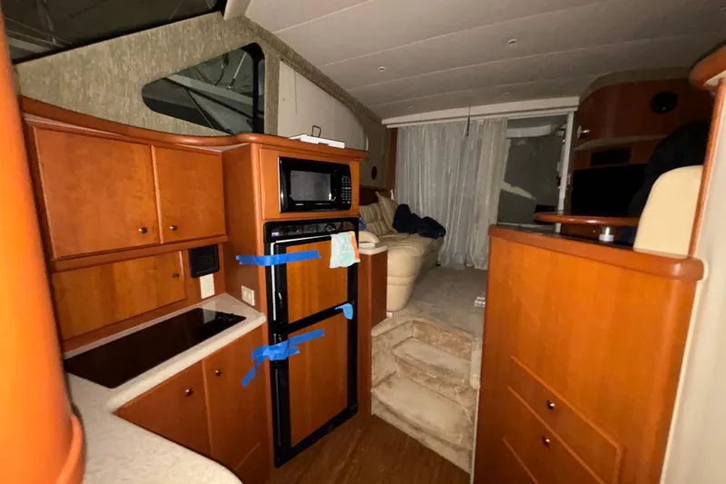  Yacht Photos Pics Interior of a 2005 Silverton 34 Convertible yacht with kitchen and seating area.