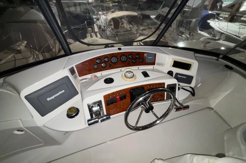  Yacht Photos Pics 2005 Silverton 34 Convertible boat helm with steering wheel and navigation instruments.