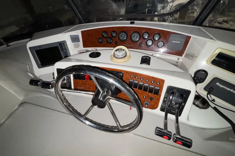  Yacht Photos Pics 2005 Silverton 34 Convertible helm with steering wheel, gauges, and navigation equipment.