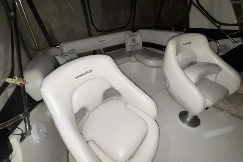  Yacht Photos Pics Interior of 2005 Silverton 34 Convertible boat with white seating and helm chairs.