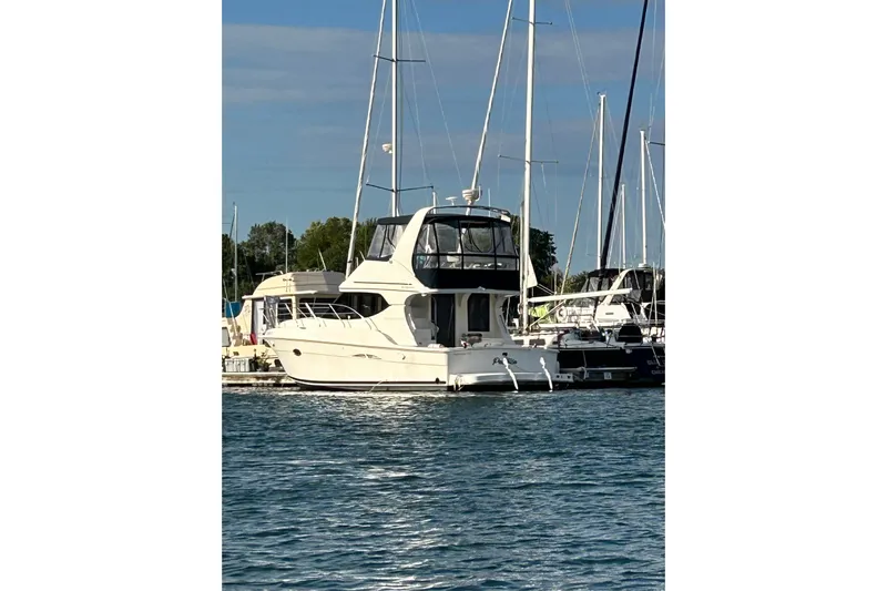  Yacht Photos Pics 2005 Silverton 34 Convertible yacht docked at marina, surrounded by sailboats.