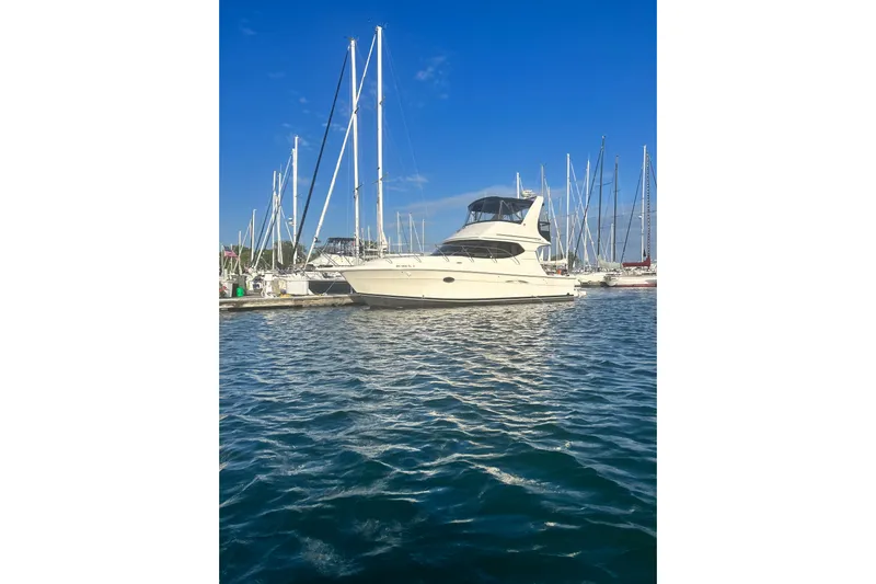  Yacht Photos Pics 2005 Silverton 34 Convertible yacht docked in a marina under clear blue skies.