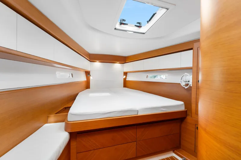 Rusalka Yacht Photos Pics Luxurious cabin interior of 2015 Italia Yachts 13.98 with wooden finish and skylight.