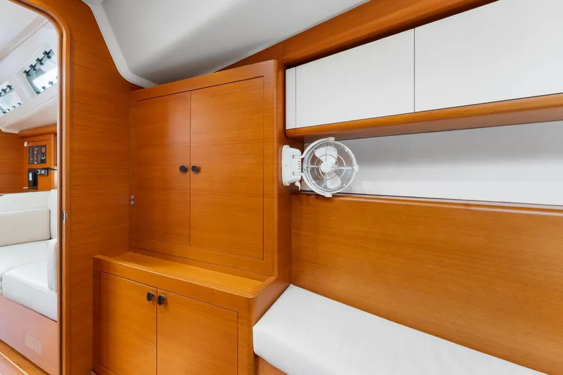 Rusalka Yacht Photos Pics Interior of 2015 Italia Yachts 13.98 with wooden cabinetry and seating area.