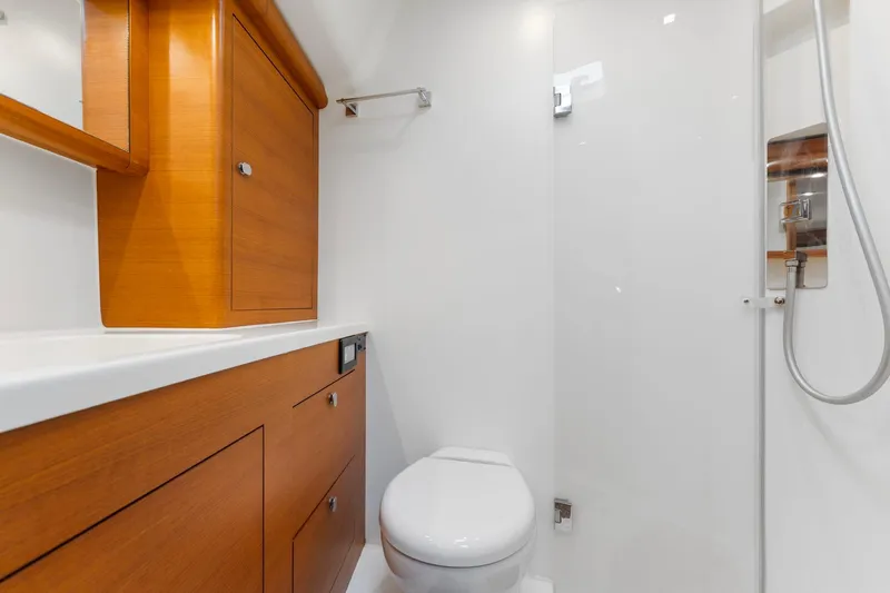 Rusalka Yacht Photos Pics Luxurious 2015 Italia Yachts 13.98 bathroom with wooden cabinetry and modern fixtures.