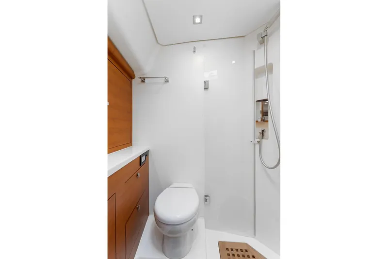 Rusalka Yacht Photos Pics Modern yacht bathroom with shower, wooden cabinetry, and toilet in 2015 Italia Yachts 13.98.