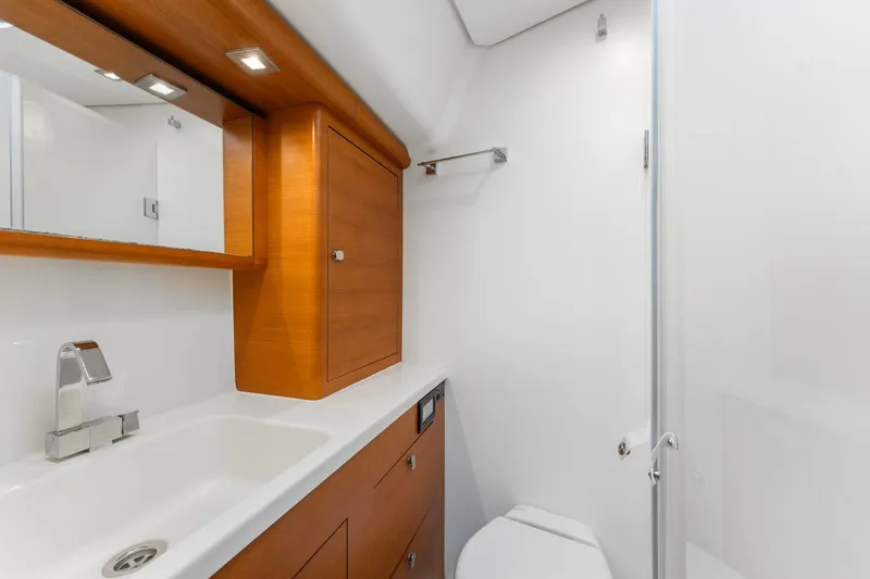 Rusalka Yacht Photos Pics Luxurious 2015 Italia Yachts 13.98 bathroom with sleek wood cabinetry and modern fixtures.