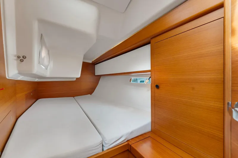 Rusalka Yacht Photos Pics Cozy cabin interior of 2015 Italia Yachts 13.98, featuring wooden finishes and a comfortable bed.