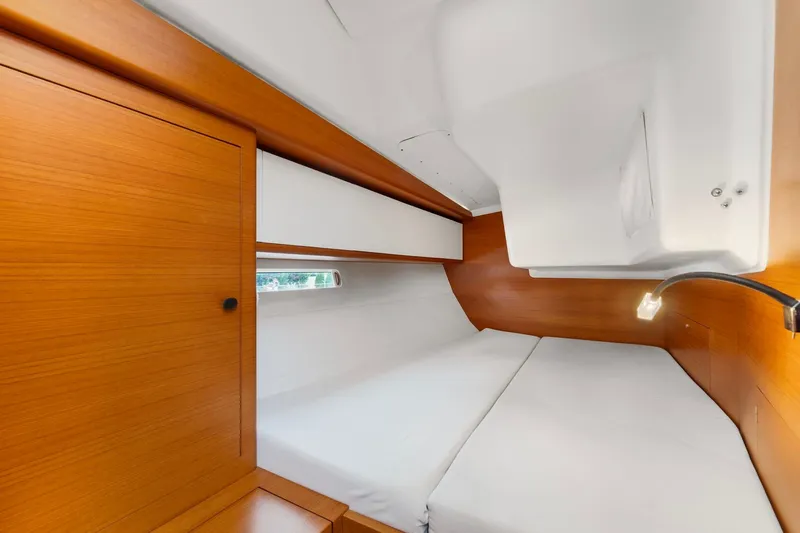 Rusalka Yacht Photos Pics Luxurious cabin interior of 2015 Italia Yachts 13.98 with wooden finish and cozy bedding.