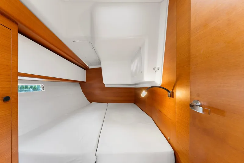 Rusalka Yacht Photos Pics Luxurious cabin interior of 2015 Italia Yachts 13.98 with wooden finish and cozy bedding.