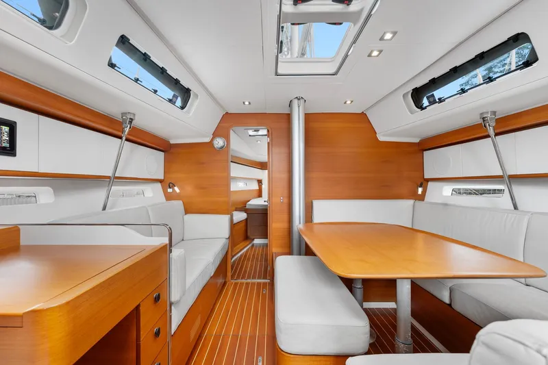 Rusalka Yacht Photos Pics Luxurious interior of 2015 Italia Yachts 13.98, featuring elegant wood and white furnishings.