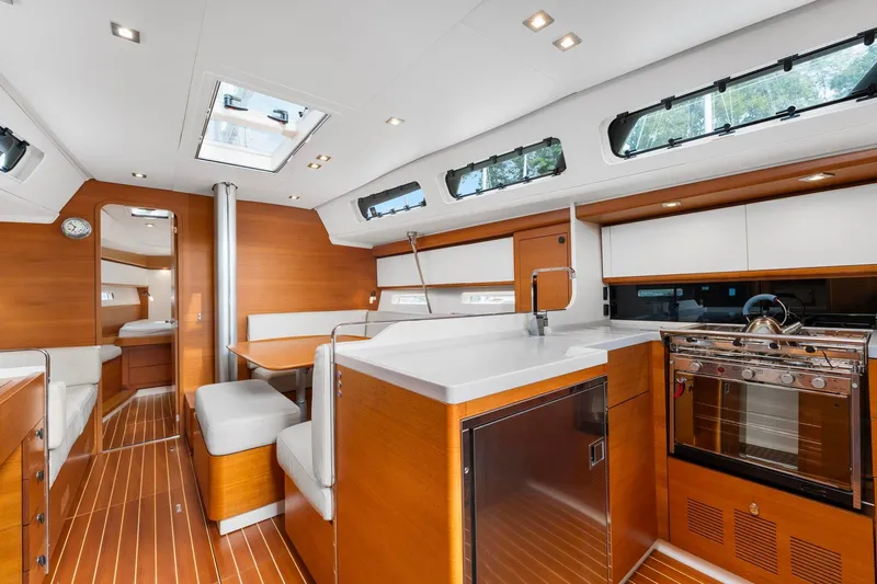 Rusalka Yacht Photos Pics Luxurious interior of 2015 Italia Yachts 13.98, featuring modern kitchen and seating area.