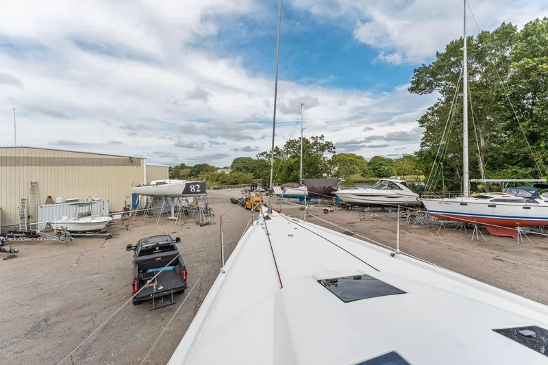 Rusalka Yacht Photos Pics Italia Yachts 13.98 (2015) in a boatyard with other vessels and equipment.