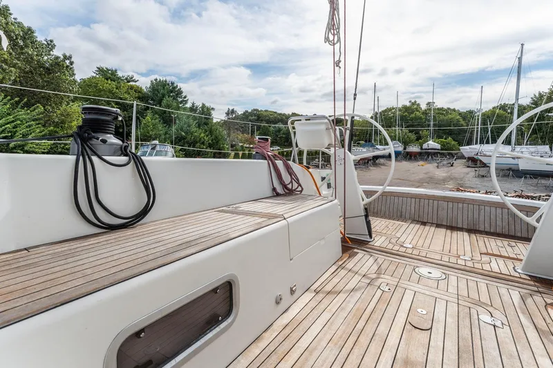 Rusalka Yacht Photos Pics Italia Yachts 13.98 (2015) sailboat deck with wooden flooring and dual steering wheels.