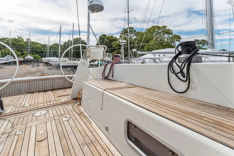 Rusalka Yacht Photos Pics Italia Yachts 13.98 (2015) sailboat deck with wooden finish and dual steering wheels.