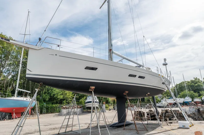 Rusalka Yacht Photos Pics Italia Yachts 13.98 sailboat from 2015 on dry dock, surrounded by other boats.