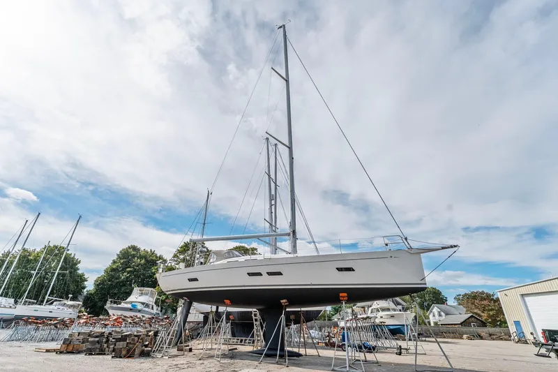 Rusalka Yacht Photos Pics Italia Yachts 13.98 sailboat from 2015 on dry dock under a cloudy sky.