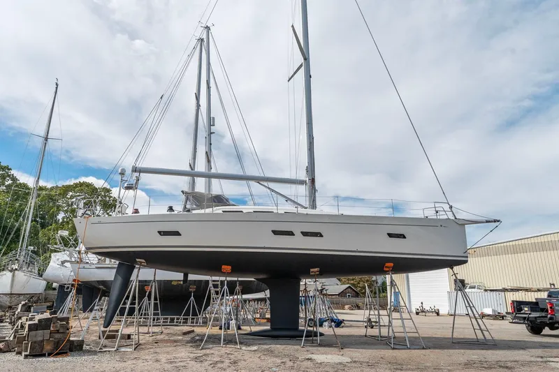 Rusalka Yacht Photos Pics Italia Yachts 13.98 sailboat from 2015 on dry dock, surrounded by other boats.