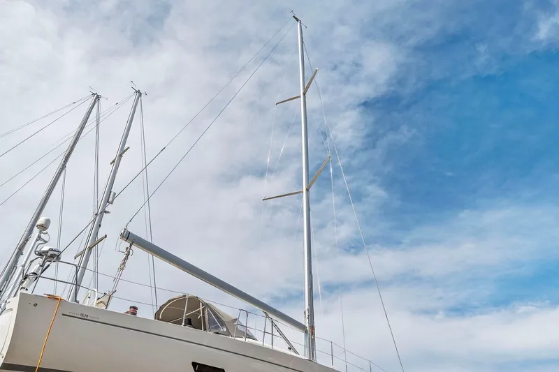 Rusalka Yacht Photos Pics Italia Yachts 13.98 sailboat, 2015 model, with tall masts against a cloudy sky.