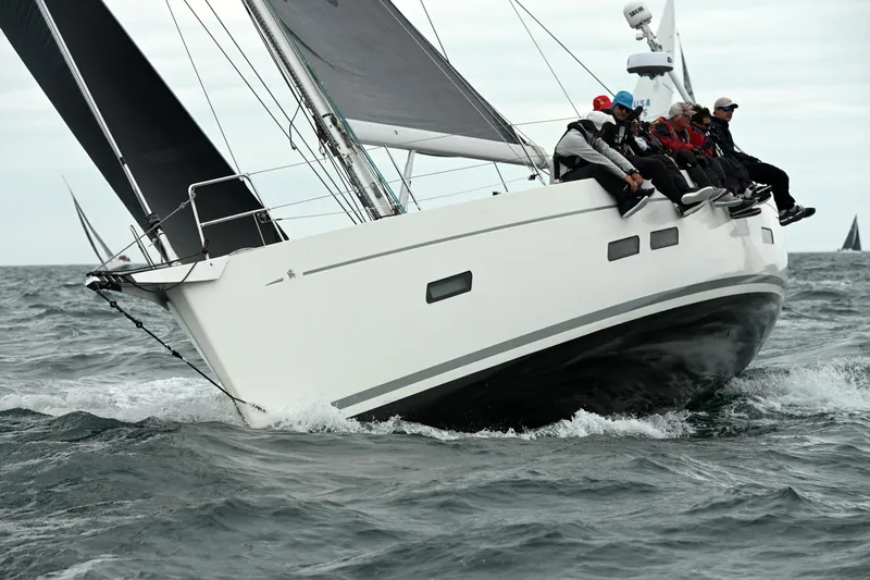 Rusalka Yacht Photos Pics Italia Yachts 13.98 sailing with crew, 2015 model, cutting through ocean waves.