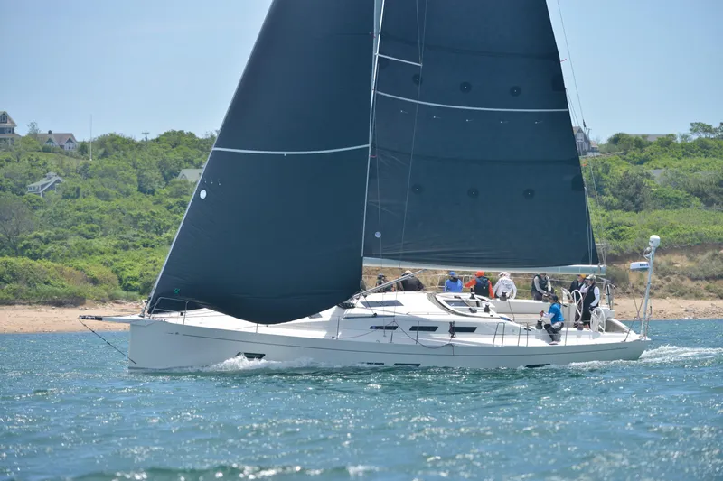 Rusalka Yacht Photos Pics Italia Yachts 13.98 sailing near the coast, 2015 model, with crew onboard.