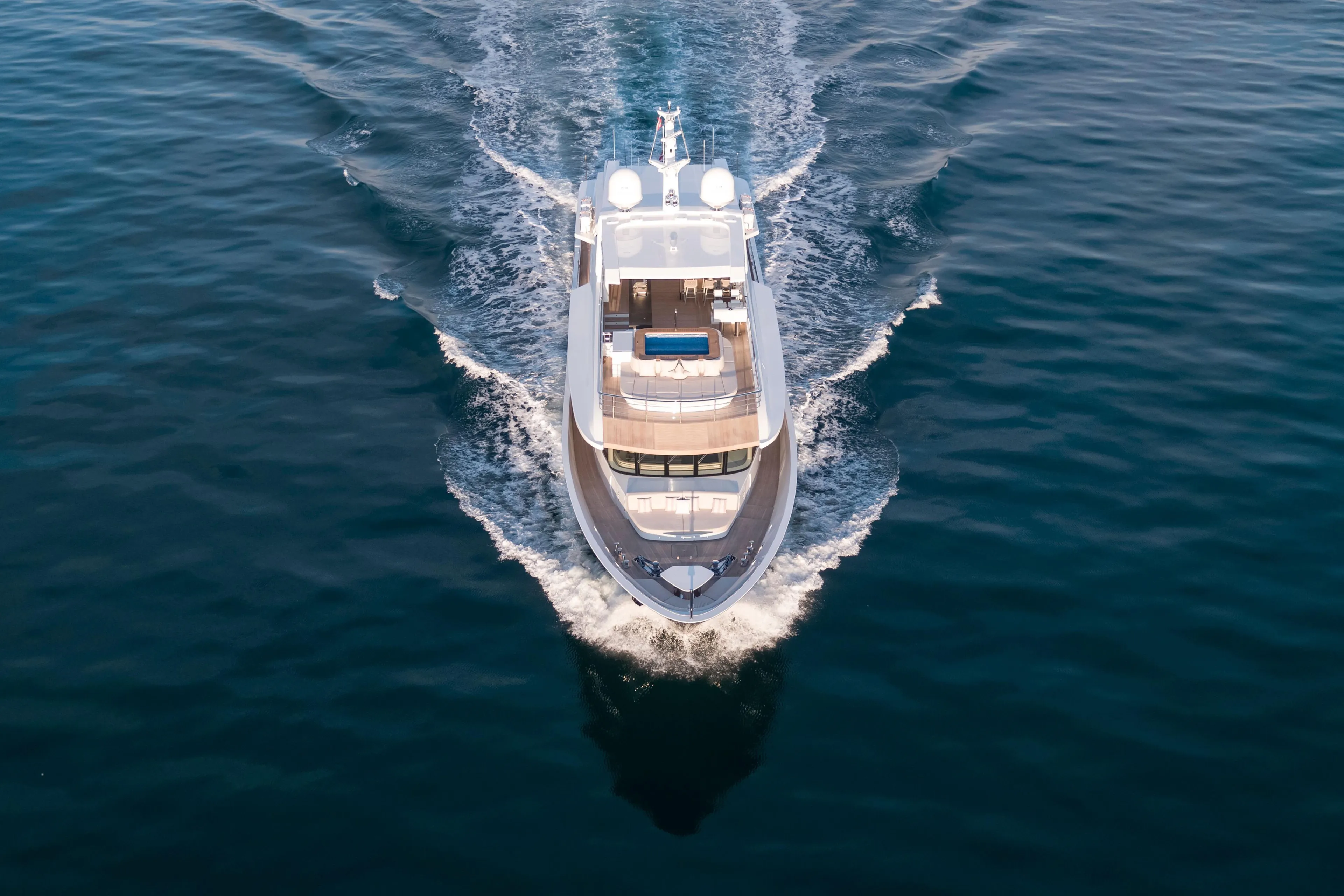 Luxury yacht Alpha Alfresco 125 cruising on open water, 2020 model.